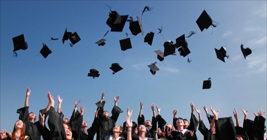 seniors graduation caps in the air
